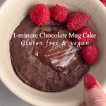 chocolate mug cake in a bowl with raspberries and dark chocolate