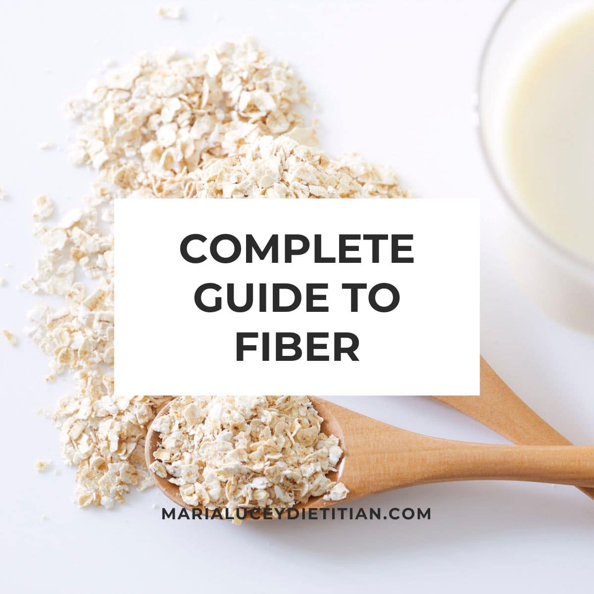 Complete guide to fiber graphic with oats on a wooden spoon and a glass of milk in the background.