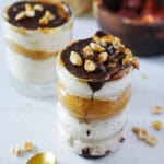 Snickers overnight oats in a jar with chocolate caramel oozing out of the top.