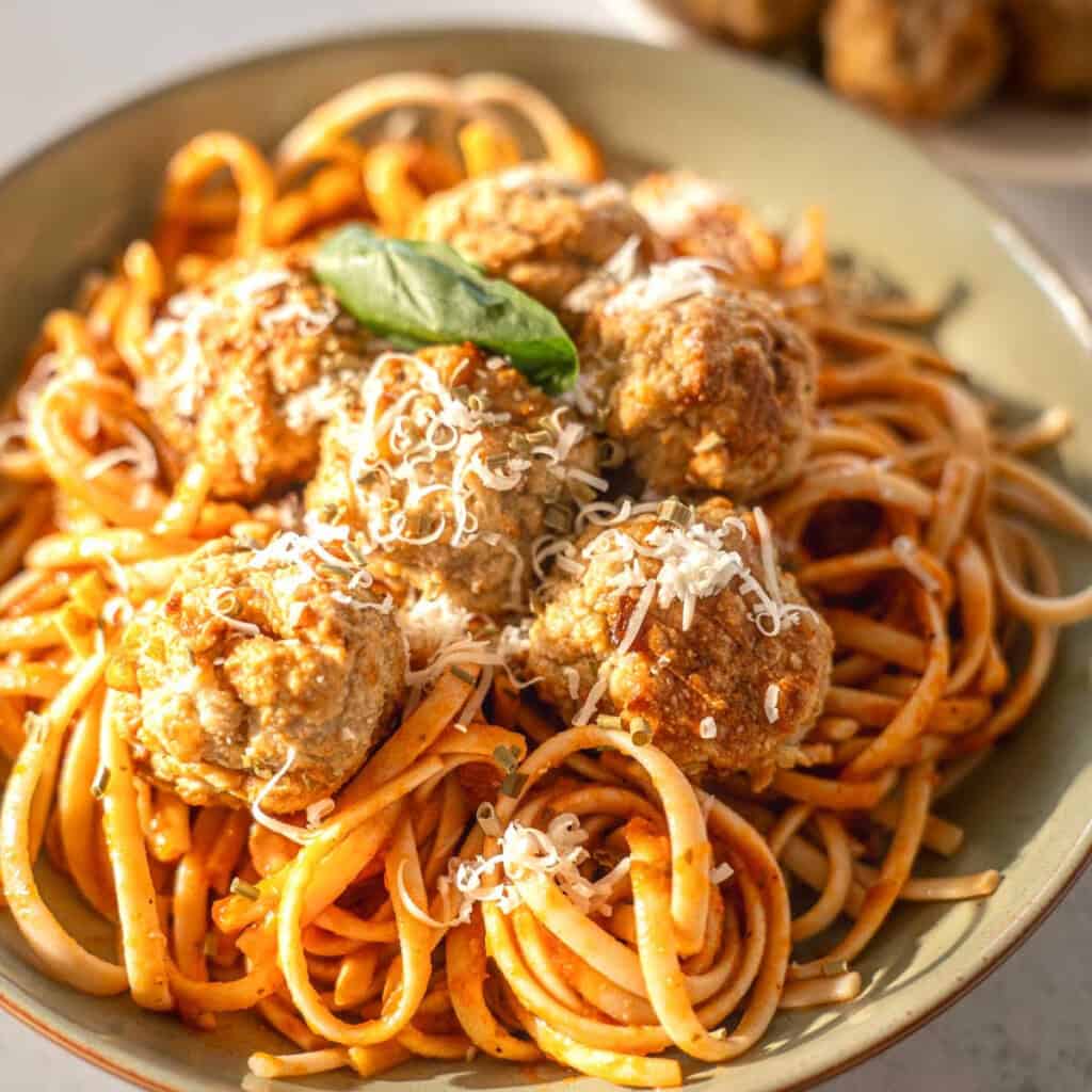 air fryer turkey meatballs in a bowl with pasta and a tomato sauce
