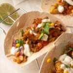 Blackened cod fish tacos in whole wheat tortillas topped with corn, beans, cilantro, and a creamy lime sauce.
