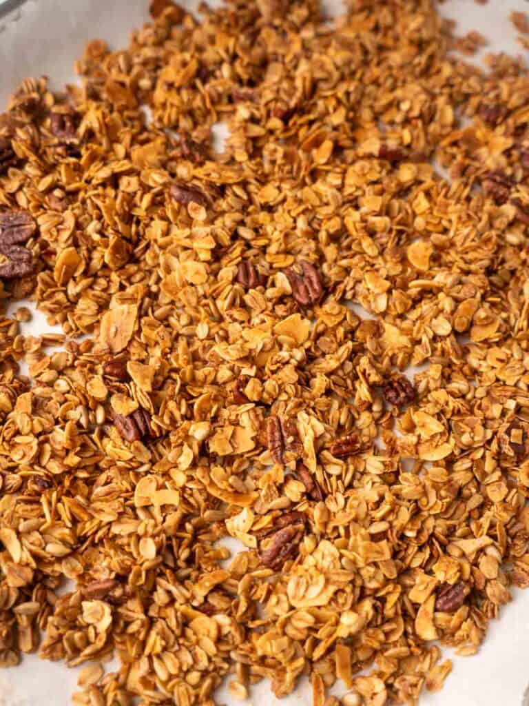 Sheet pan of homemade granola baked until golden brown with toasted oats, nuts, and seeds