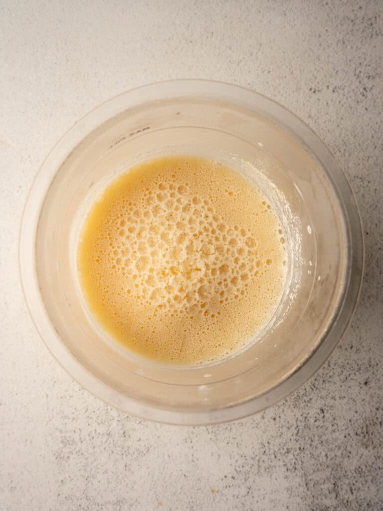 Prepared Ninja Creami vanilla ice cream base after freezing in the Creami container.