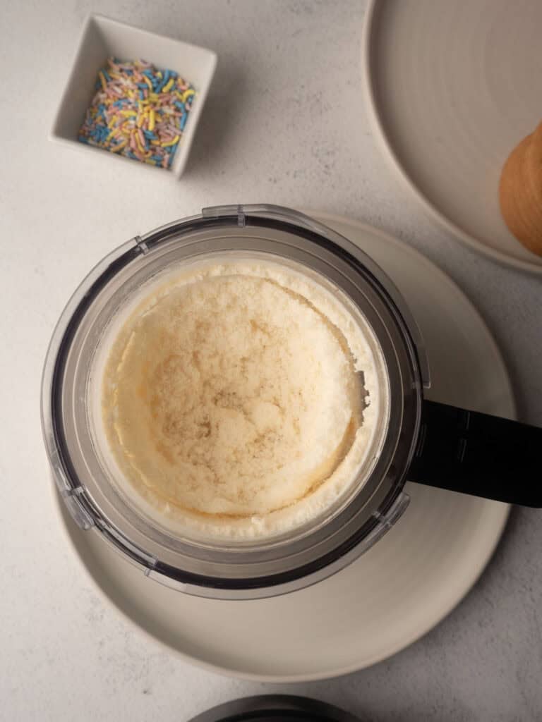 Crumbly Ninja Creami vanilla ice cream texture before respinning.