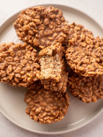 Healthy rice krispie treats made with chocolate, peanut butter, oats, and Rice Krispies cereal stacked on a plate