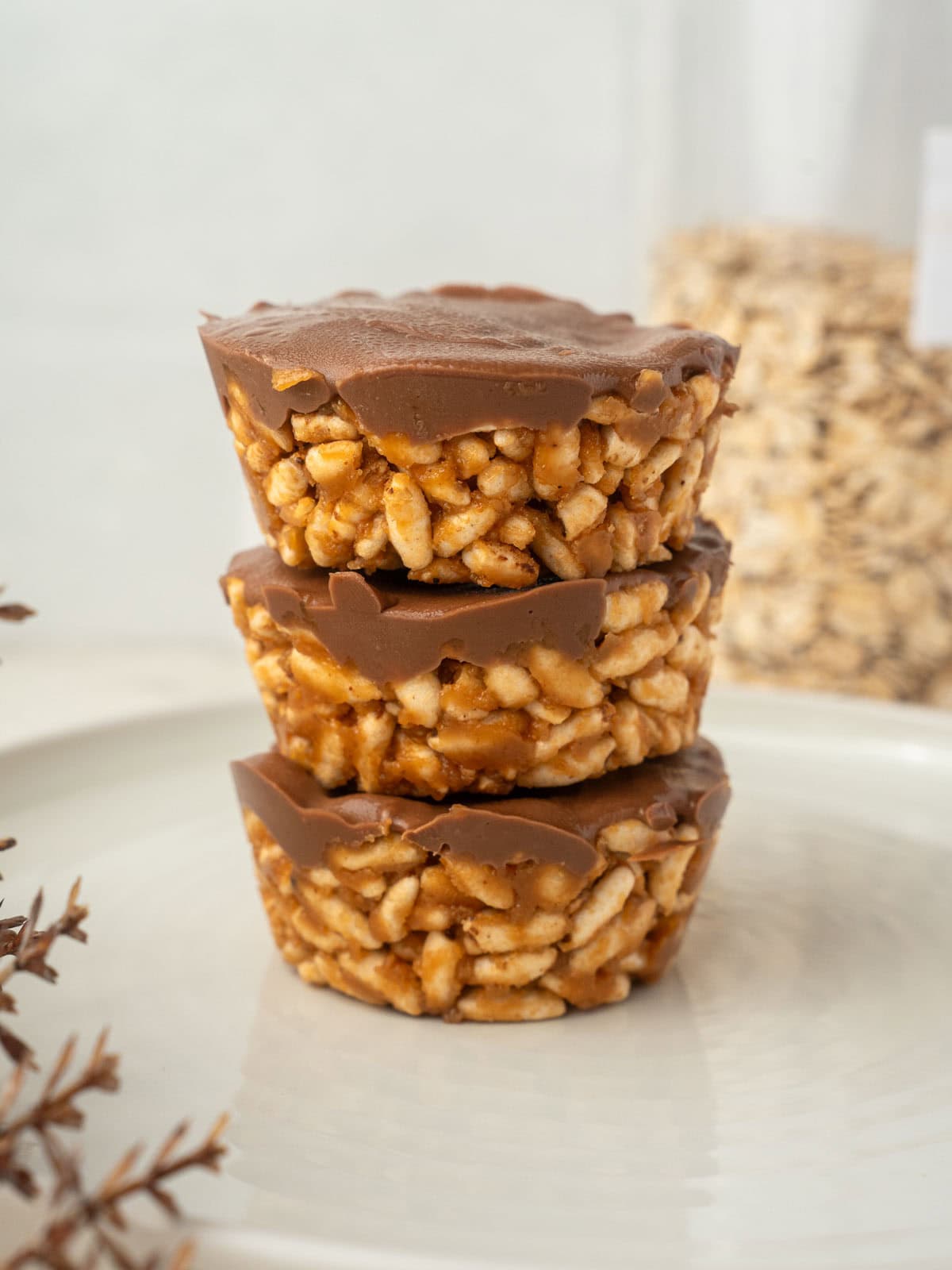 Stack of no bake peanut butter crispy cups made with chocolate and crispy rice cereal