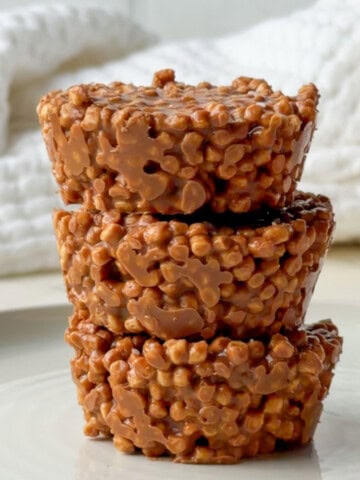Pea protein chocolate crispie cakes stacked on top of each other with a crunchy chocolate coating made from puffed pea protein cereal.