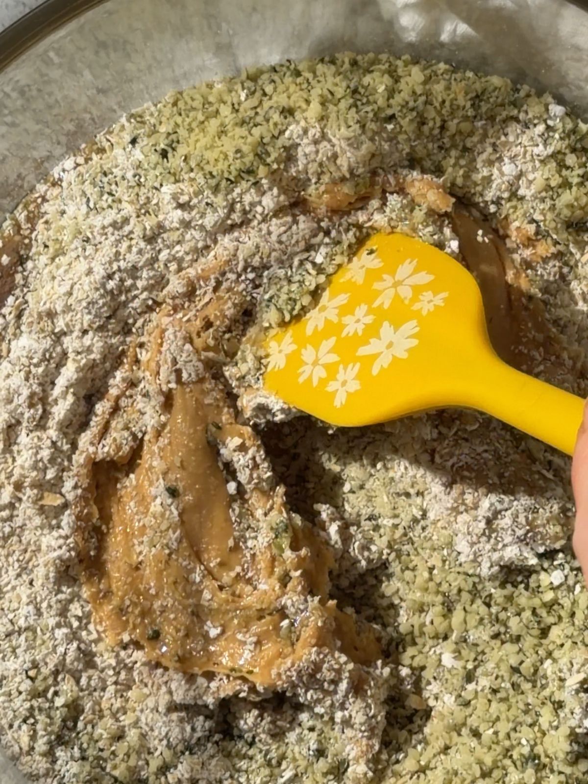 Mixing peanut butter, oat flour and hemp seeds for no-bake chocolate peanut butter hemp seed bars.