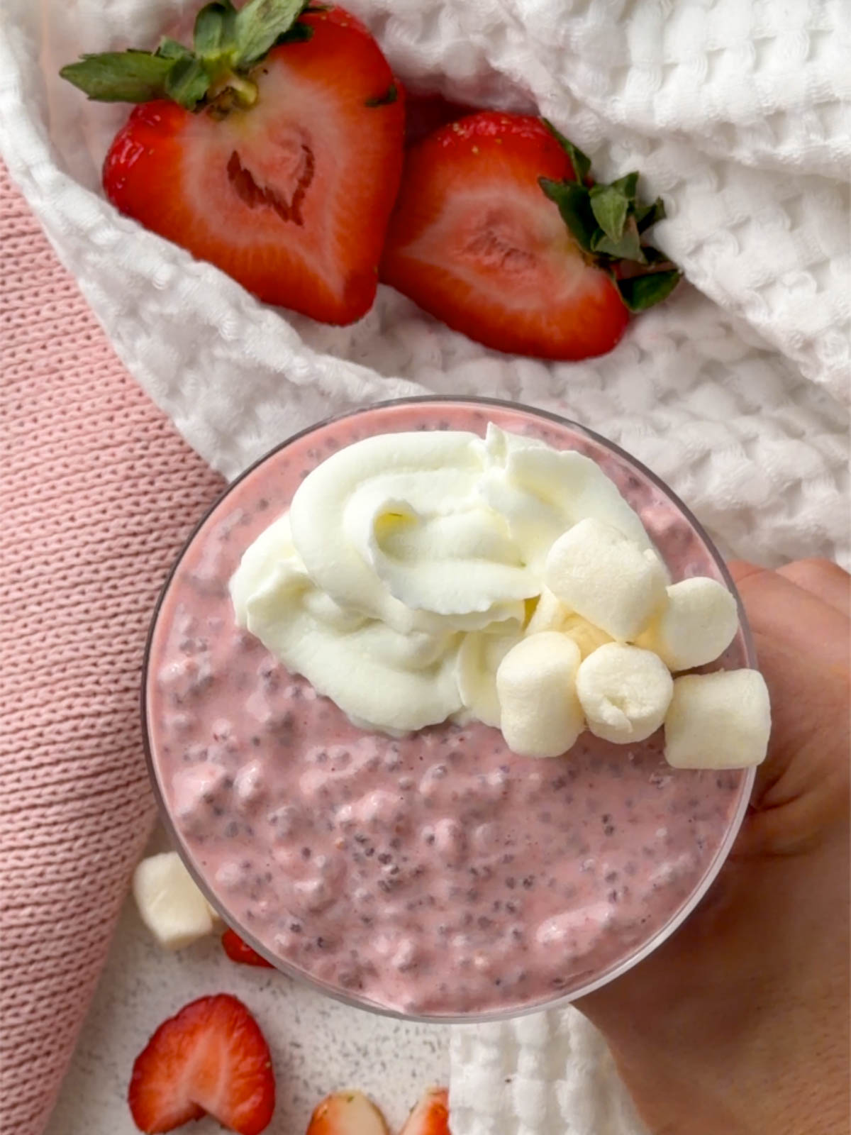 Pink strawberry chia seed pudding with creamy yogurt topping and marshmallows