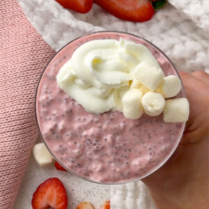 Close-up of pink strawberry chia seed pudding with creamy yogurt topping and marshmallows