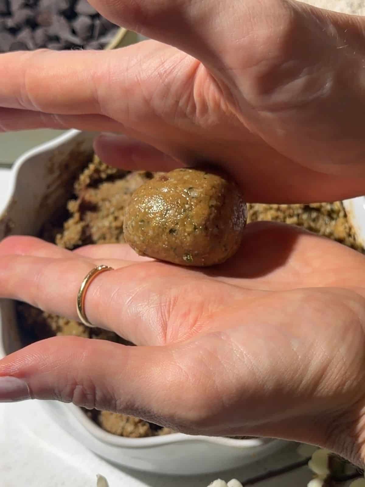 Rolling nut free protein ball mixture between hands