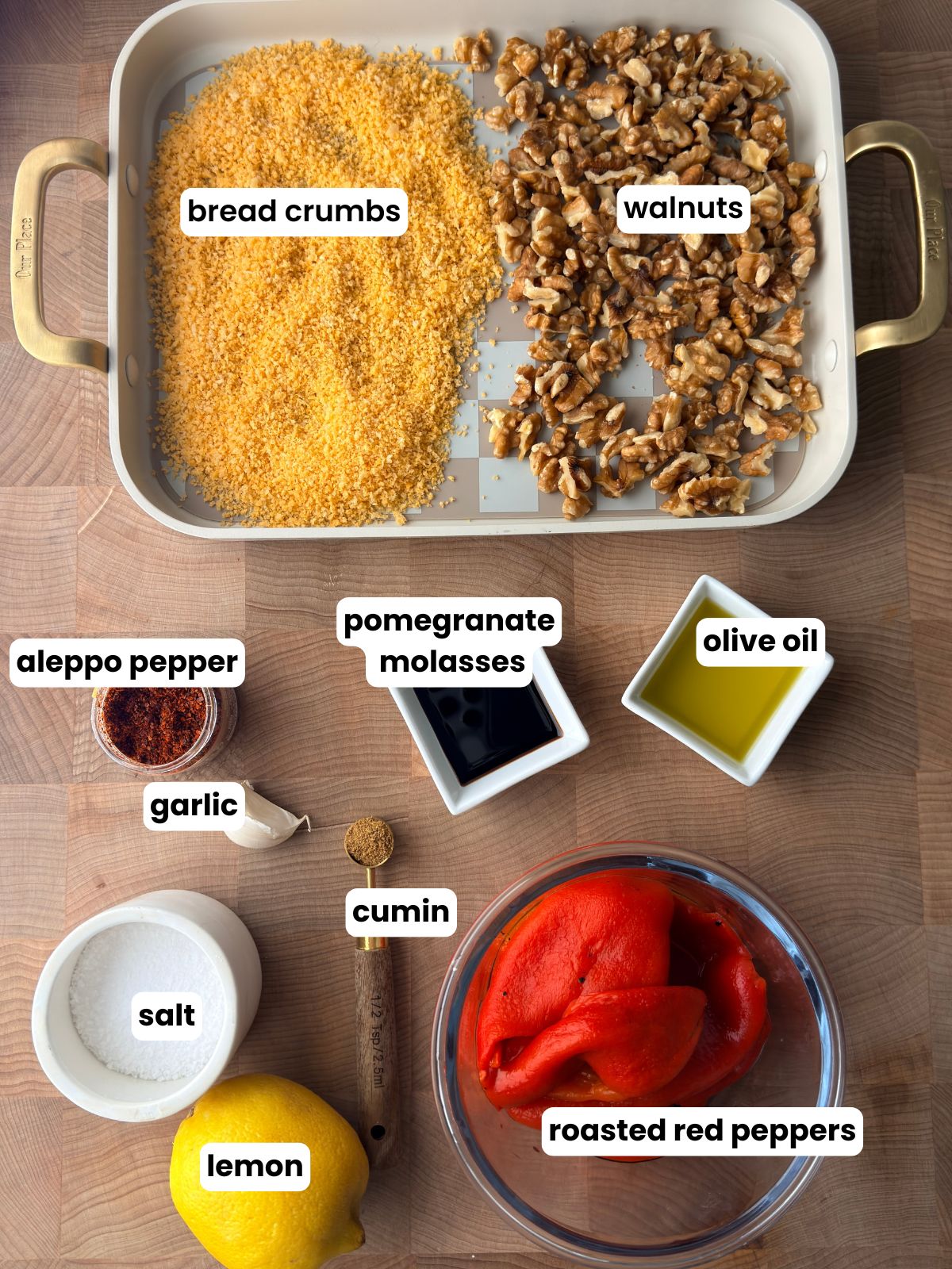 Muhammara ingredients including roasted red peppers, walnuts, breadcrumbs, pomegranate molasses, olive oil, Aleppo pepper, garlic, cumin, salt and lemon.